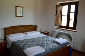 マッサ・マルターナにあるAgriturismo La Collinaのベッドルーム1室(ベッド1台、タオル2枚付)