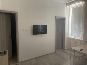 a living room with a flat screen tv on a wall at Villa History in Crikvenica