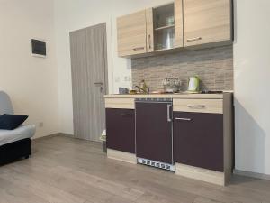 a kitchen with a sink and a stove top oven at Villa History in Crikvenica