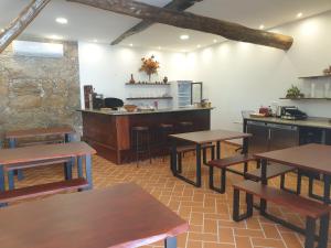 a restaurant with tables and a counter in a room at Casa do Visconde in Alcaide