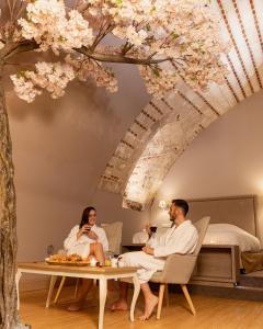 a man and a woman sitting in a room with a table at La Parenthèse Envoutée in Amiens