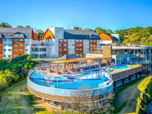 a resort with a large swimming pool in a city at Laghetto Resort Golden Oficial - Particular in Gramado