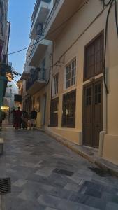 an empty street in a city with buildings at ERRIKA in Ermoupoli