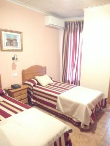 Łóżko lub łóżka w pokoju w obiekcie Hotel Mesón el Castillo