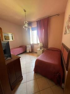 a bedroom with two beds and a television in it at B&B La Casa di Zia Lina in Monsummano Terme