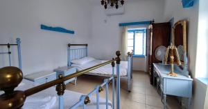 a bedroom with two bunk beds and a window at Αρχοντικό ΑΤΤΙΚ - ATTIK MANSION in Livadi