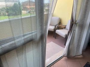 a view of a window with curtains and a chair at Casa Palma in San Donato