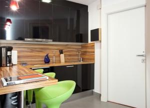 a kitchen with a wooden counter and a green chair at City Center Apartment in Barcelona