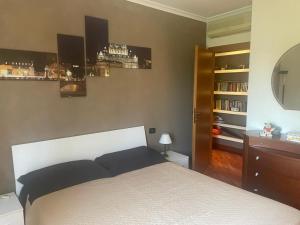 a bedroom with a bed and a shelf with books at Casa Antonella in Rome