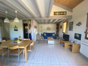 a living room with a table and a couch at Park Village Océlandes in Saint-Julien-en-Born