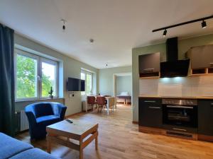 a living room with a blue couch and a table at Sankt Anna Resort in Sankt Anna