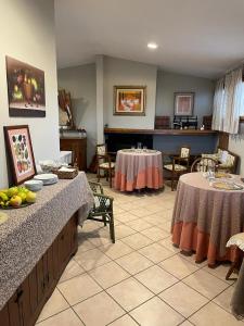 a large room with two tables and a piano at B&B La Casa di Zia Lina in Monsummano Terme