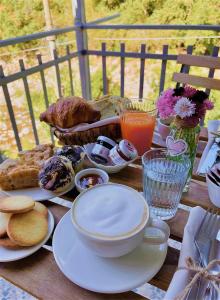 a table with plates of food and drinks on it at Agriturismo Agagin in Agaggio Inferiore