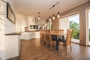 a kitchen and dining room with a table and chairs at Beachfront Villa Grace with heated rooftop pool in Jadranovo