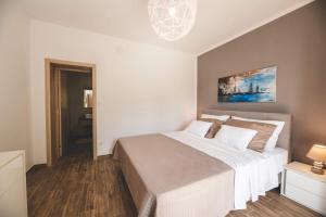 a bedroom with a large bed in a room at Beachfront Villa Grace with heated rooftop pool in Jadranovo +32 photos