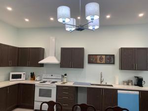 a kitchen with wooden cabinets and a stove top oven at Waterfront Q Estate summer cottage in Westport