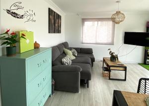 a living room with a couch and a table at Cozy apartment Benidorm Poniente 5 min from the beach in Benidorm