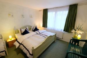 a bedroom with a bed and a large window at Luxus-Ferienhaus auf Reiterhof ART.Quartier in Velgast