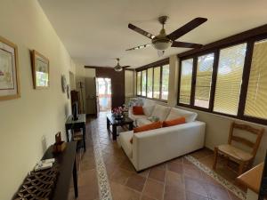 a living room with a couch and a ceiling fan at VILLA en Playa La Barrosa in Chiclana de la Frontera