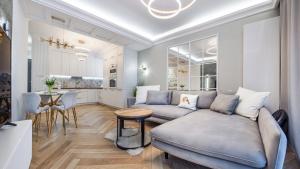 a living room with a couch and a table at Sagaris z basenem, Sun & Snow in Dziwnów