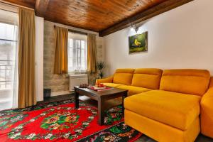 a living room with a couch and a table at Stara Čaršija Hotel & SPA in Bar