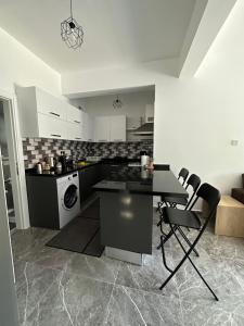 a kitchen with a table and chairs in a room at Ozbilge Apartments in Kyrenia