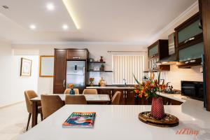 a kitchen and living room with a table and chairs at A pretty holiday home in Malta’s fishing village in Marsaxlokk
