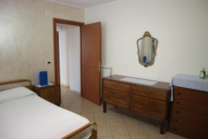 a bedroom with a bed and a dresser and a mirror at Casa Dolce Casa in Vacri