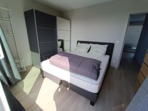 a bedroom with a large bed in a room at Koksijde Penthouse in Koksijde