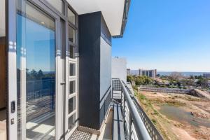 a balcony with a view of the city at The Median Rosebank Luxury Apartment - Building with Generator in Johannesburg