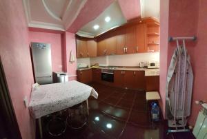 a kitchen with wooden cabinets and a counter top at appartments in Batumi in Batumi