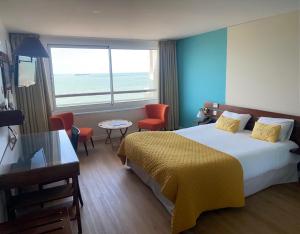 a hotel room with a large bed and a window at LOGIS HOTEL - La Petite Rade in Le Havre