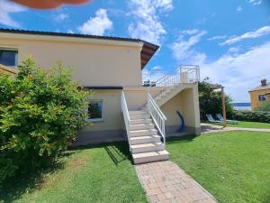 a staircase leading to a house with a grass yard at Apartments Pronavtik in Piran