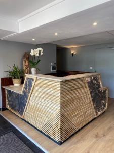a lobby with a reception desk in a room at LOGIS HOTEL - La Petite Rade in Le Havre