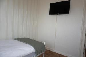 a bedroom with a bed and a flat screen tv on the wall at Ferienwohnung Oderwind in Oderberg