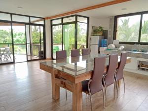 a dining room with a glass table and chairs at Heart of Mother Earth (HOME) Resort in Aringay