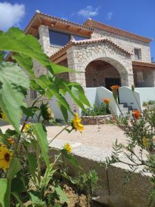 a villa with a garden in front of a house at Black Pearl Apartment Lithakia Zakynthos in Lithakia