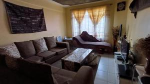 a living room with a couch and a table at Nakuru Lovely 2bedroom Master ensuite in Nakuru
