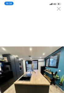 a kitchen with a wooden counter top in a room at Villa proche Disneyland paris 5 chambres 