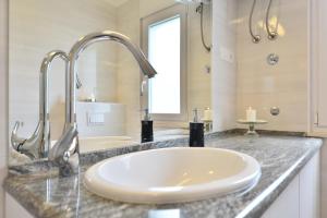 a bathroom counter with a sink and a tub at Villa Sarah in Supetar +21 photos