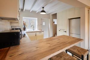 a kitchen with a wooden counter top in a room at Host & Stay - Dale End in Kirkbymoorside