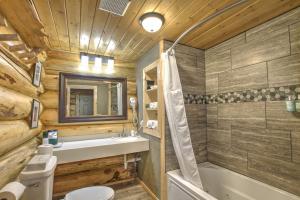 a bathroom with a toilet and a sink and a tub at Hibernation Station in West Yellowstone