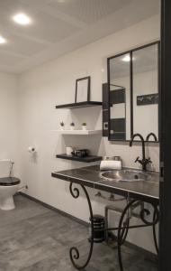 a bathroom with a sink and a toilet at Nouveau - Nina - Loft - Europa Park Rulantica in Obenheim