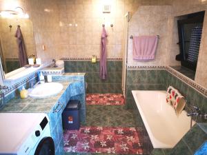 a bathroom with a tub and a sink and a bath tub at Apartment Sončni Mokec in Rečica ob Savinji