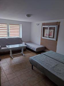 a room with two beds and a table in it at Spokojny nocleg w Centrum in Augustów