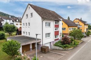 a white house with red doors on a street at Sonnenschein in Zell am Harmersbach