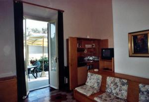 a living room with a door open to a patio at Villa San Domenico in Castiglioncello