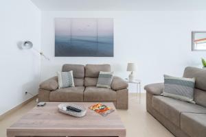 a living room with a couch and a coffee table at Delightful Cabanas 2 Bedroom apartment in Cabanas de Tavira