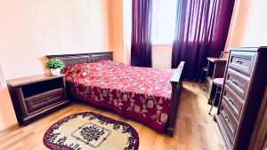 a small bedroom with a bed and a dresser at Blaz in Odesa