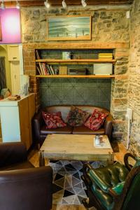 a living room with a couch and a coffee table at Manorbier House - St Anne's Room in Tenby